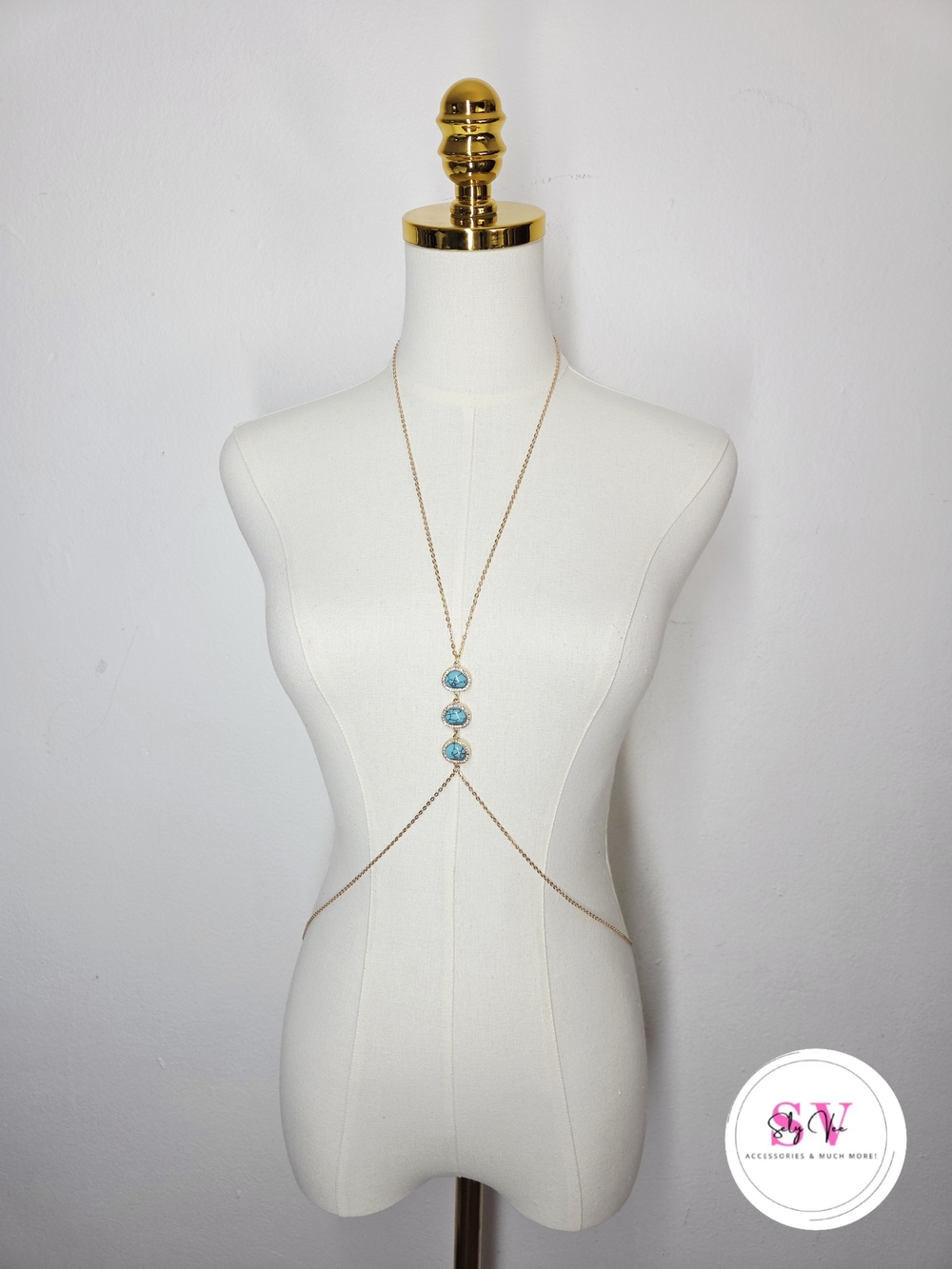 Gold body chain with three turquoise accents.
